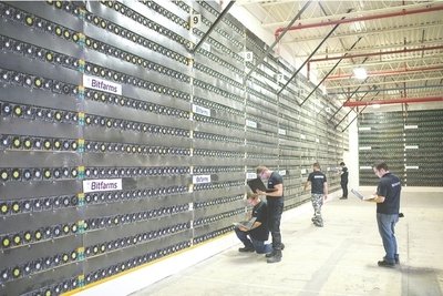 A large mining farm located in a country with cheap electricity, servers are neatly arranged.